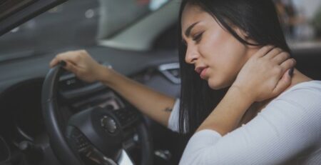 Woman in a car suffering from injury