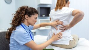 Chiropractor Doing Healing Treatment on Woman's Back