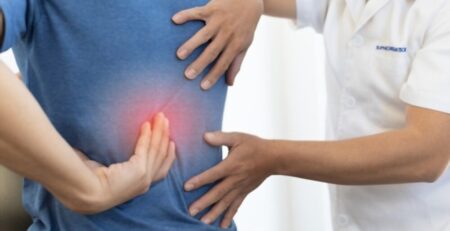 Chiropractor Diagnosing Patients Back Pain