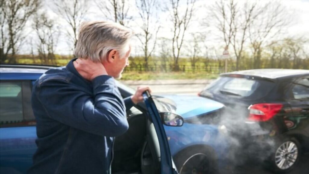 Senior Male Driver Gets Whiplash Injury During Car Accident