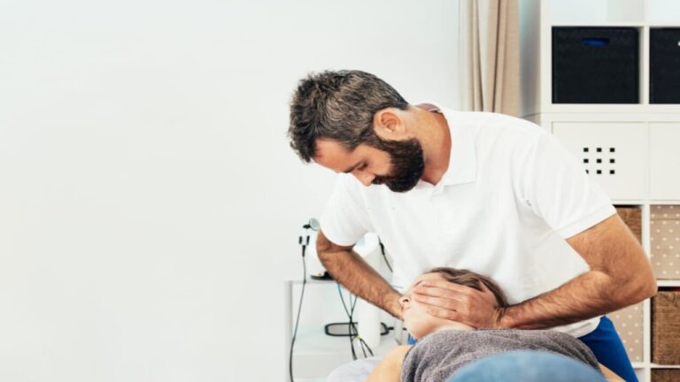 Physiotherapist treating patient for neck injury